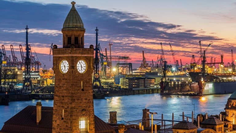 Ein Uhrturm in der Abenddämmerung im Hamburger Hafen.