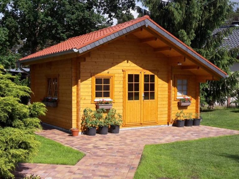 Eine kleine Blockhütte in einem Hinterhof.